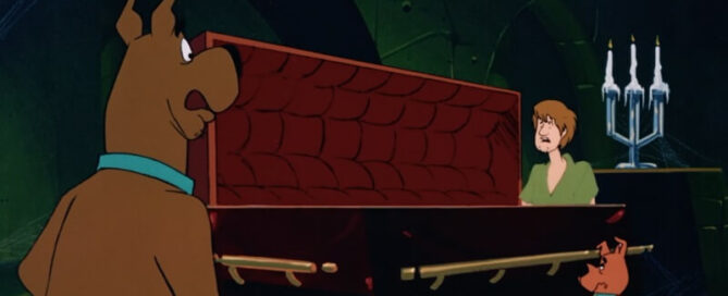 Shaggy looking at a coffin