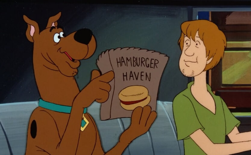 Scooby holding a hamburger haven bag