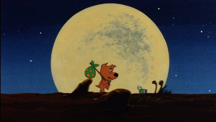 Scrappy walking in front of the moon kicking a can