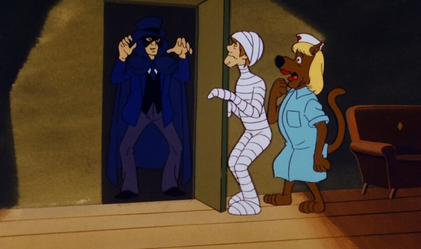 Shaggy in a body cast being terrified by the Phantom, and Scooby dressed as a nurse