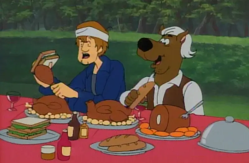 Scooby and Shaggy eating lots of food.